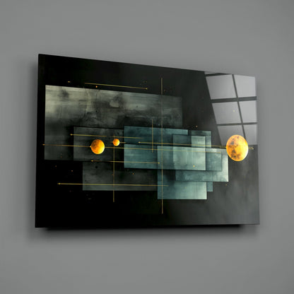 Modern glass wall art featuring two glowing orange planets connected by gold lines against dark and teal layered background on gray wall.