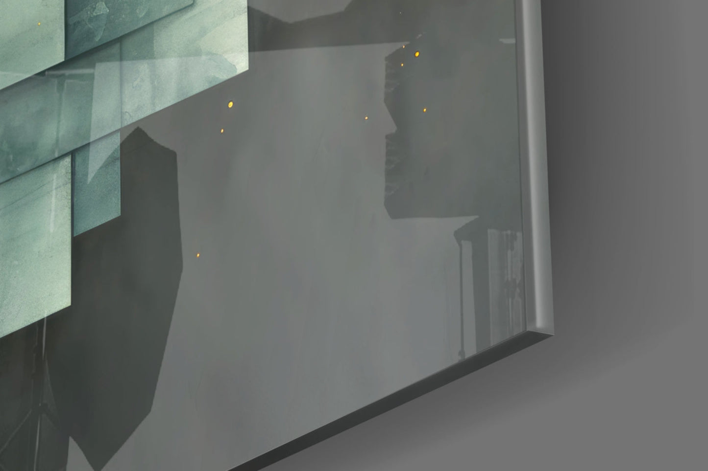 Modern glass wall art depicting silhouetted cityscape with illuminated windows against misty gray background.