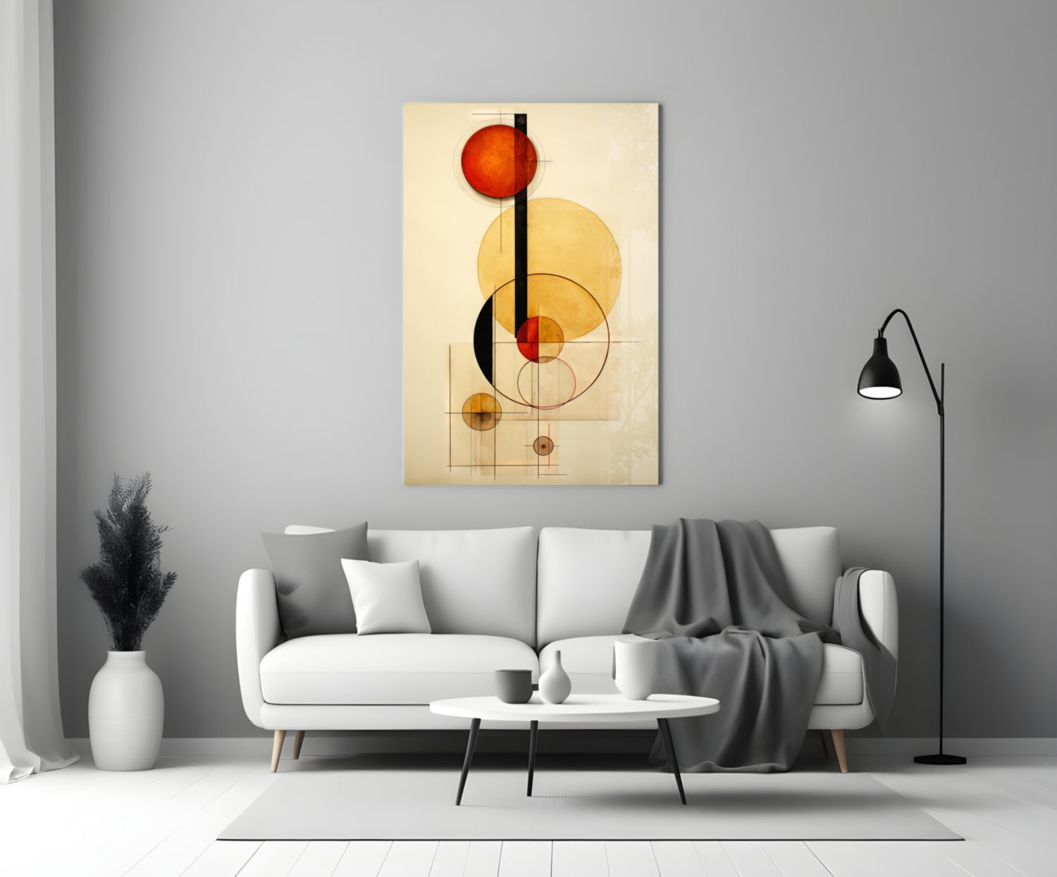 Abstract geometric glass wall art with red, yellow, and black circles and lines displayed above a white sofa in a modern living room.