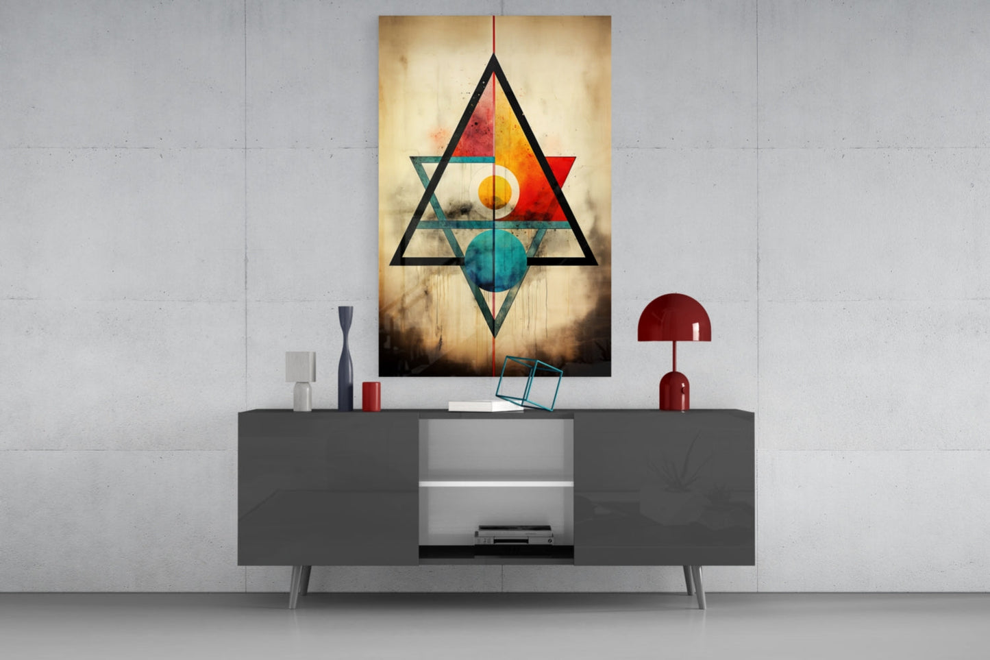 Geometric glass wall art featuring interlocking triangles in black, red, orange, and teal with circular elements, displayed above a dark console table in a modern interior setting.