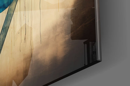Close-up angled view of glass wall art with beige, tan, and brown abstract brushstroke design and hanging wires against white wall.