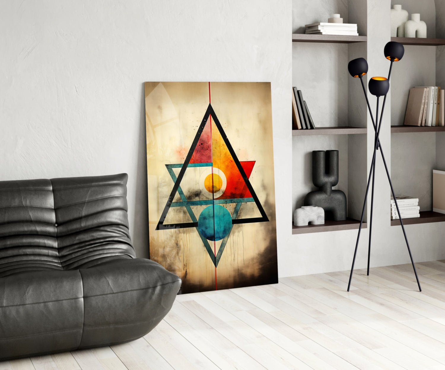 Geometric glass wall art featuring nested triangles in black with colorful circles in red, orange, yellow, and teal on cream background, displayed in modern living room setting.