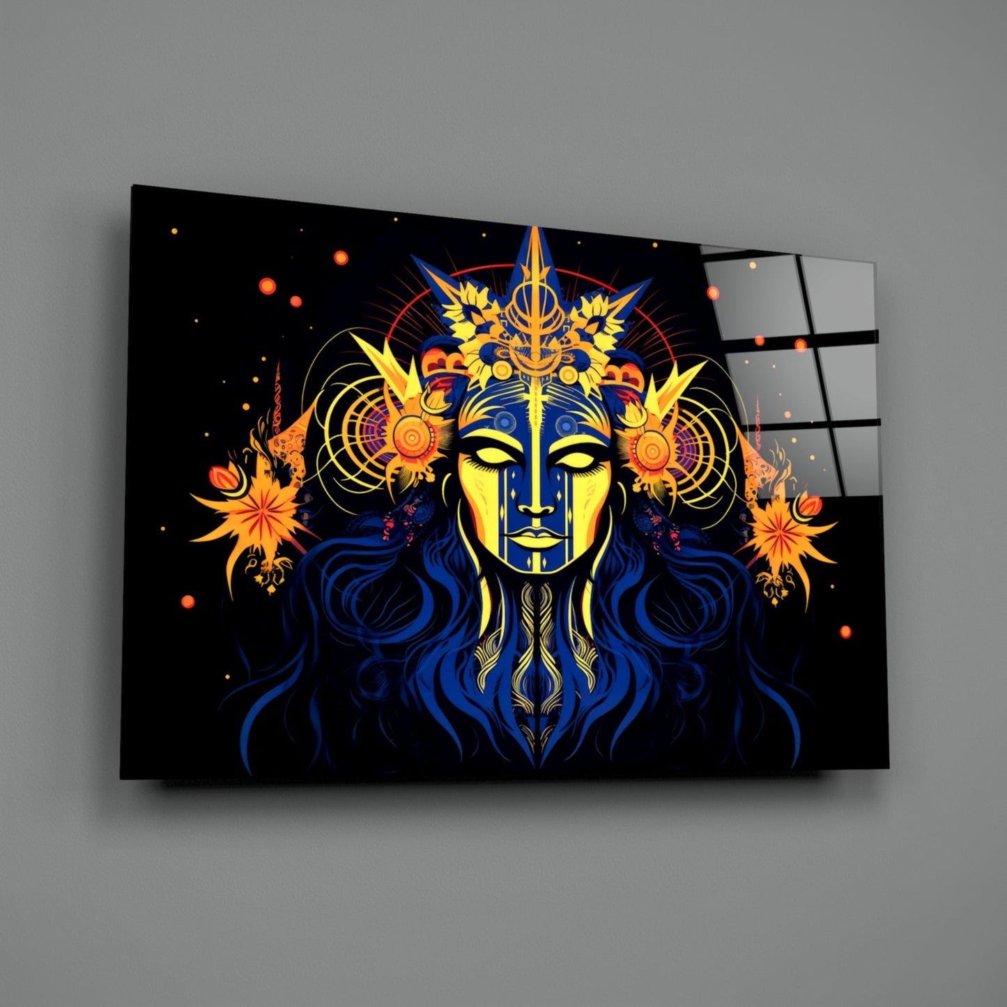 Glass wall art panel displaying a mystical face with yellow and blue coloring, ornate gold crown, blue hair, and orange floral designs on black background.