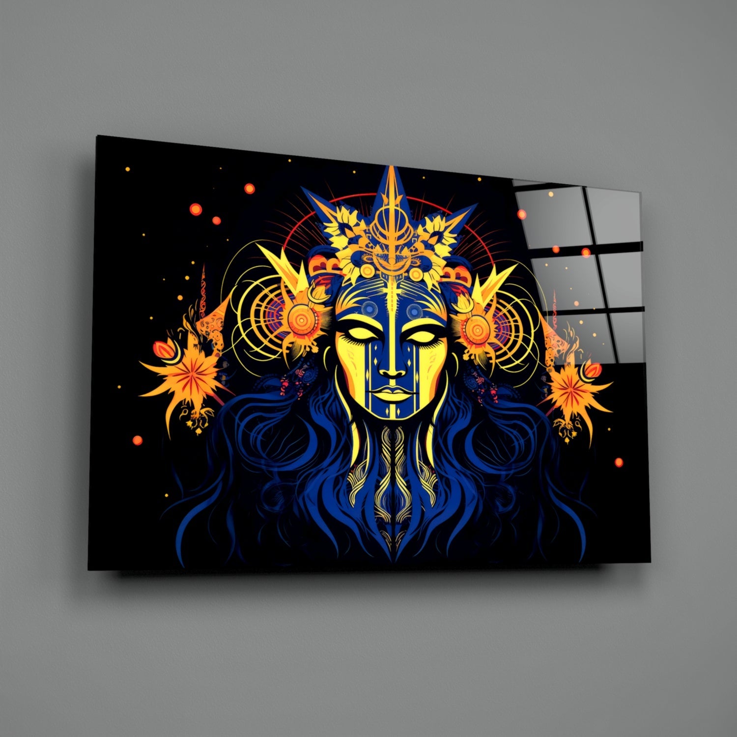 Glass wall art panel displaying a mystical face with yellow and blue coloring, ornate gold crown, blue hair, and orange floral designs on black background.