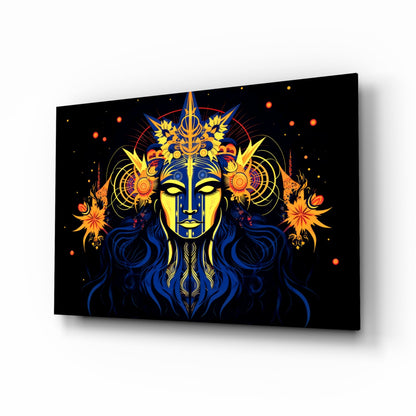 Glass wall art panel displaying a mystical blue and yellow face with ornate gold crown, orange flowers, and cosmic elements on black background, shown at angled perspective.