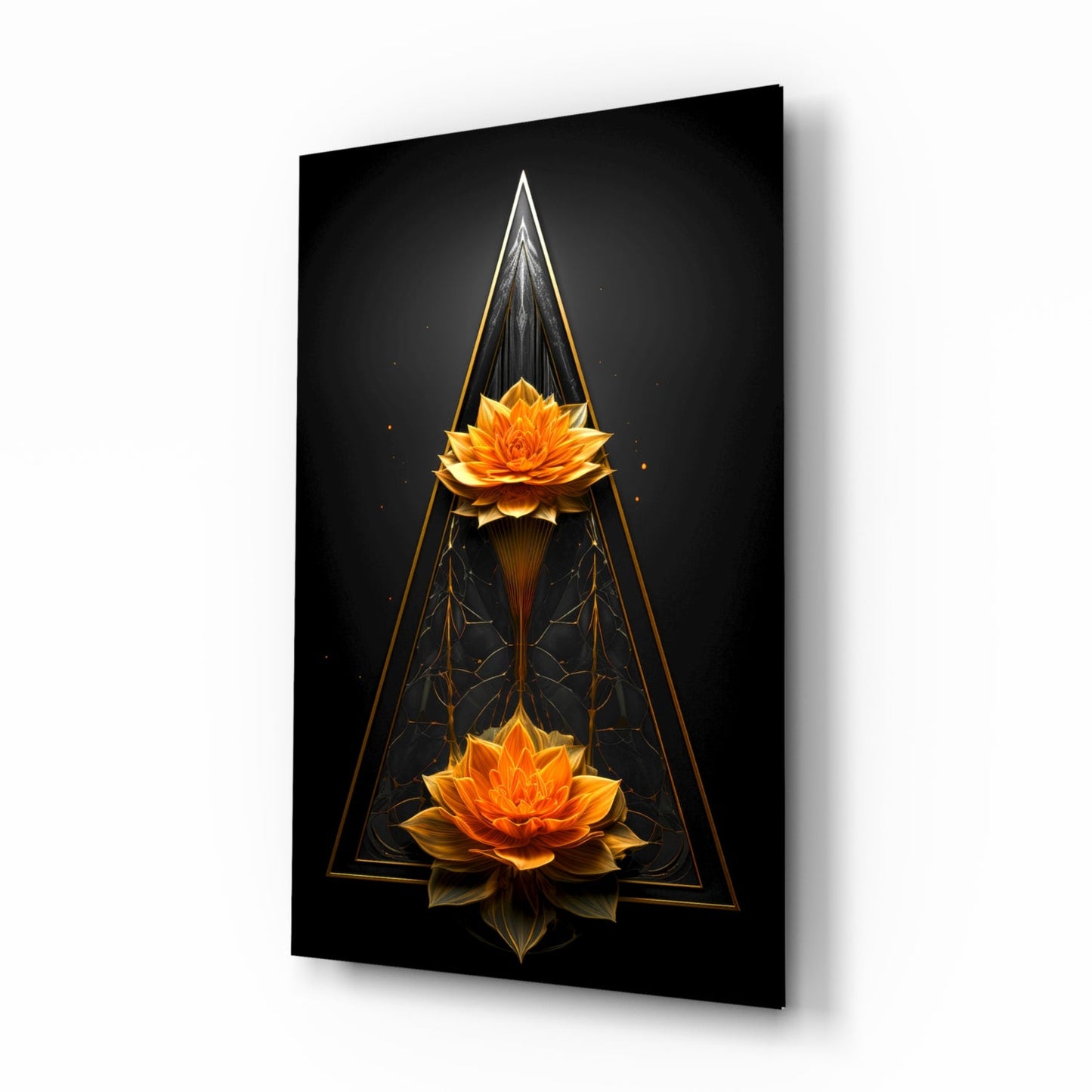 Angled view of black glass wall art featuring two golden lotus flowers vertically aligned within geometric triangular frames against dark background.