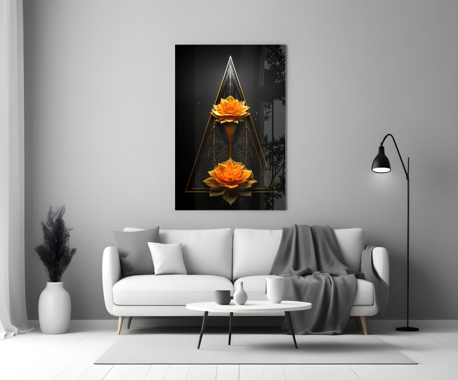 Black glass wall art featuring two glowing golden lotus flowers arranged vertically within geometric gold triangular frames on dark background, displayed above white sofa in modern living room.