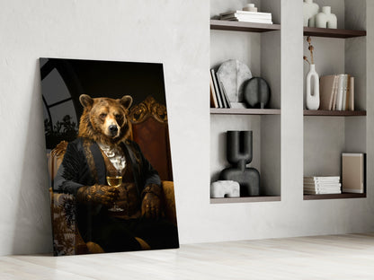 Glass wall art leaning against white wall displays bear in black jacket holding wine glass, with styled shelving visible behind.