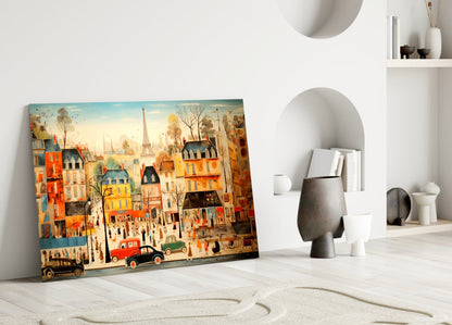 Colorful illustrated glass art depicting a vibrant Parisian street scene with buildings, Eiffel Tower, and vintage cars, leaning against a white wall beside sculptural home décor.