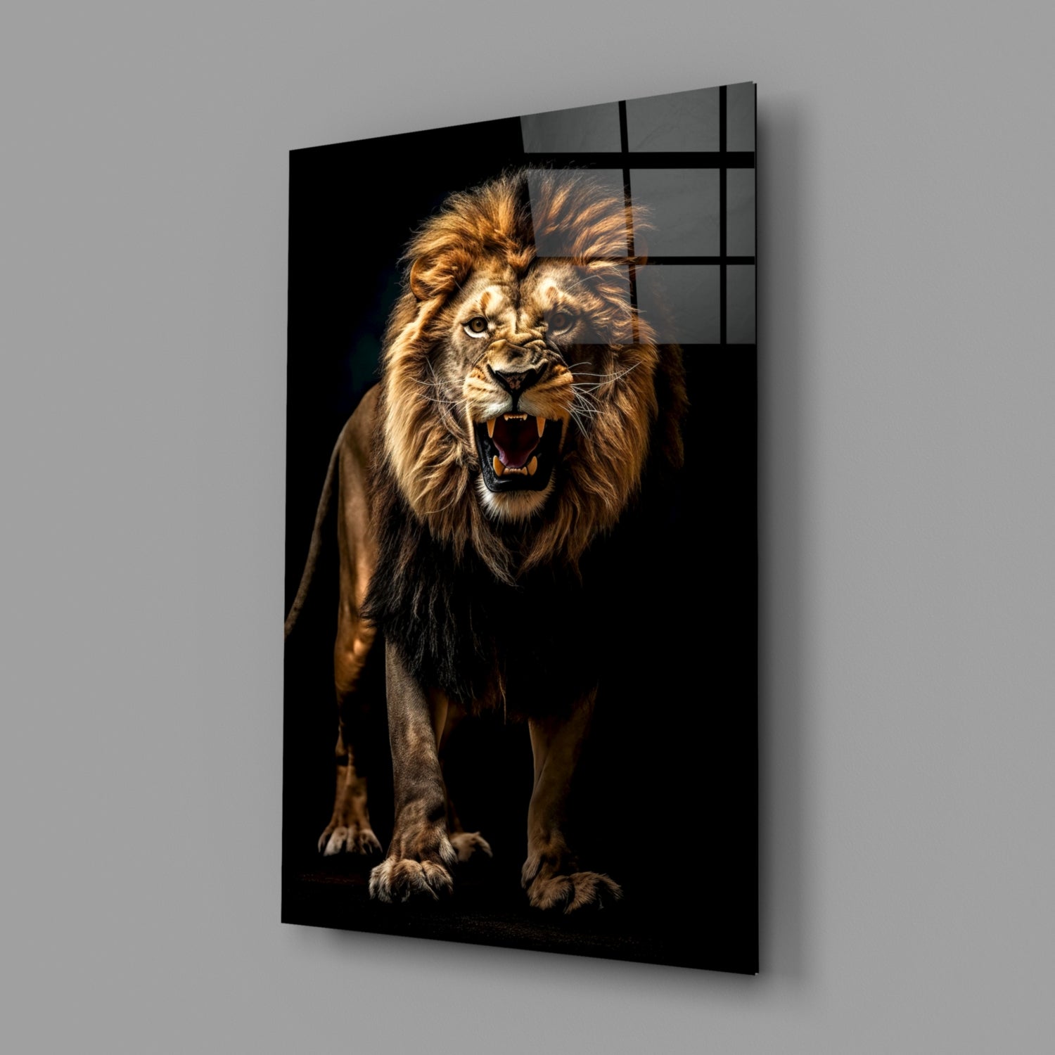 Angled side view of a glass wall art panel displaying a roaring lion with golden mane against black background, mounted on gray wall.