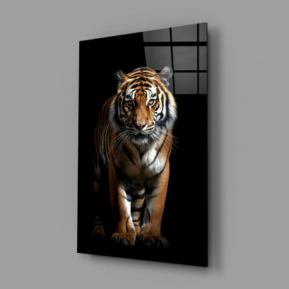 Glass wall art panel displaying a front-facing tiger on black background, mounted at an angle showing the gridded glass frame detail.