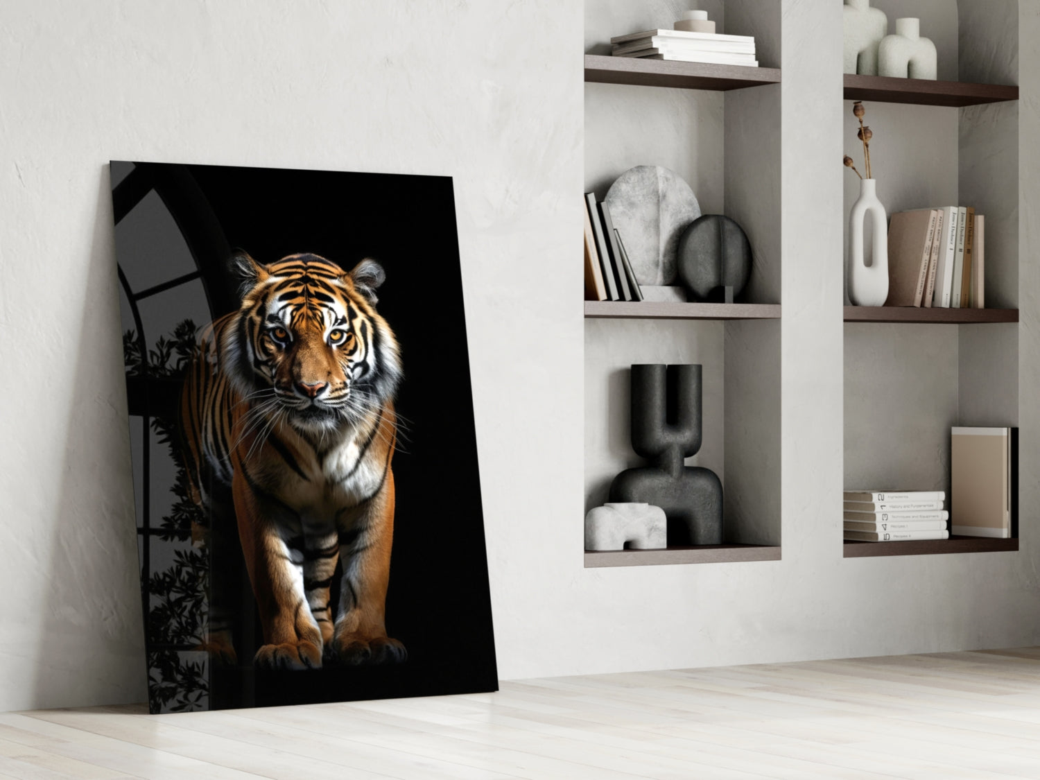 Tiger glass wall art leaning against white wall beside shelving unit displaying books and decorative objects.
