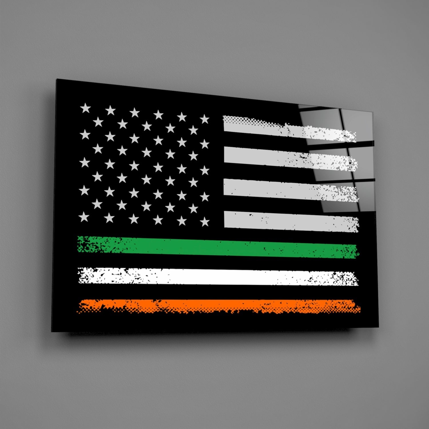Black glass wall art featuring distressed American flag with white stars and stripes, green, white, and orange horizontal bands at bottom, mounted on gray wall.