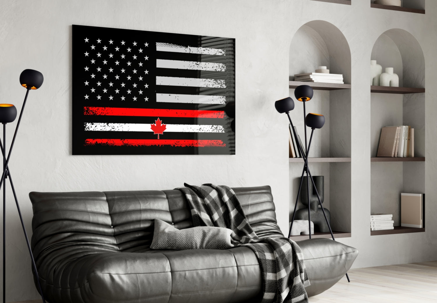 Black glass wall art featuring distressed USA and Canadian flags with red maple leaf stripe, displayed above gray leather sofa in modern living room.