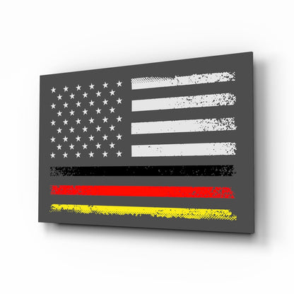 Angled perspective view of a dark gray glass wall art panel featuring a distressed American flag with white stars and stripes, overlaid with red and yellow horizontal bands at the bottom.