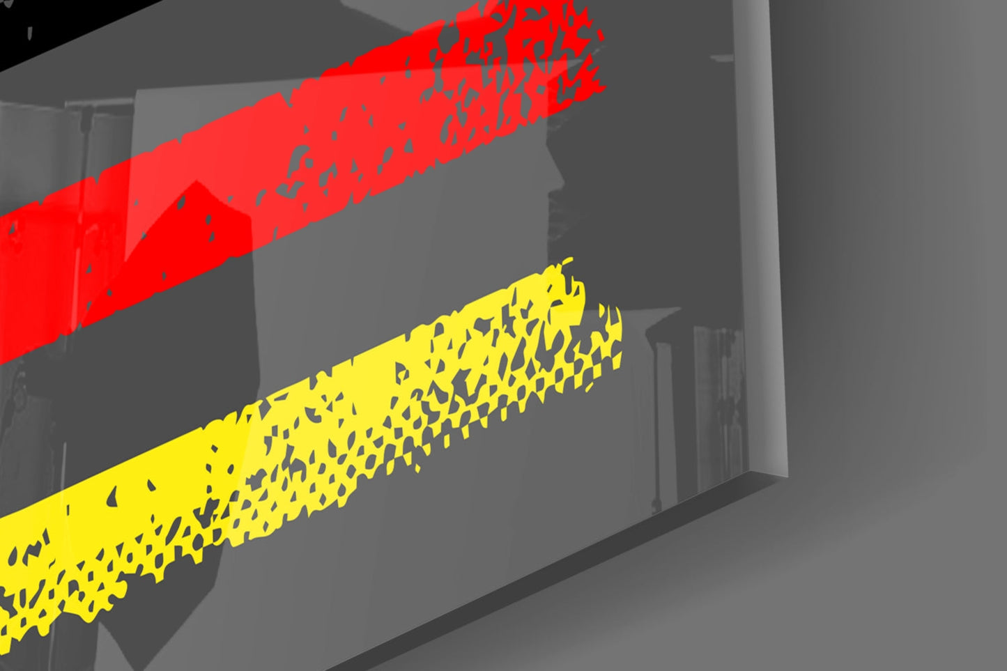 Close-up angled view of red and yellow glass strips with textured surfaces against a gray interior wall background.