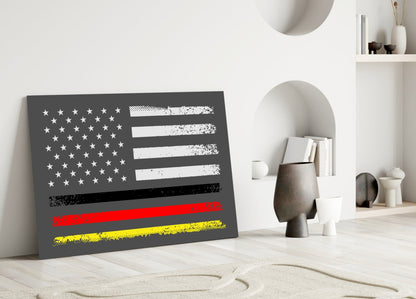 Distressed USA-Germany flag glass wall art leaning against white wall in minimalist room setting with decorative objects.
