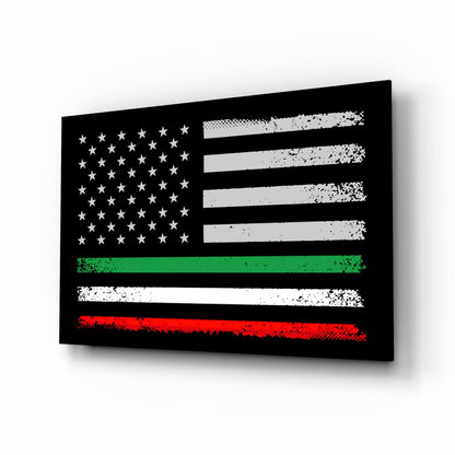 Black glass panel displaying distressed American flag with white stars and gray stripes, overlaid with green and red horizontal stripes, angled 3/4 view.