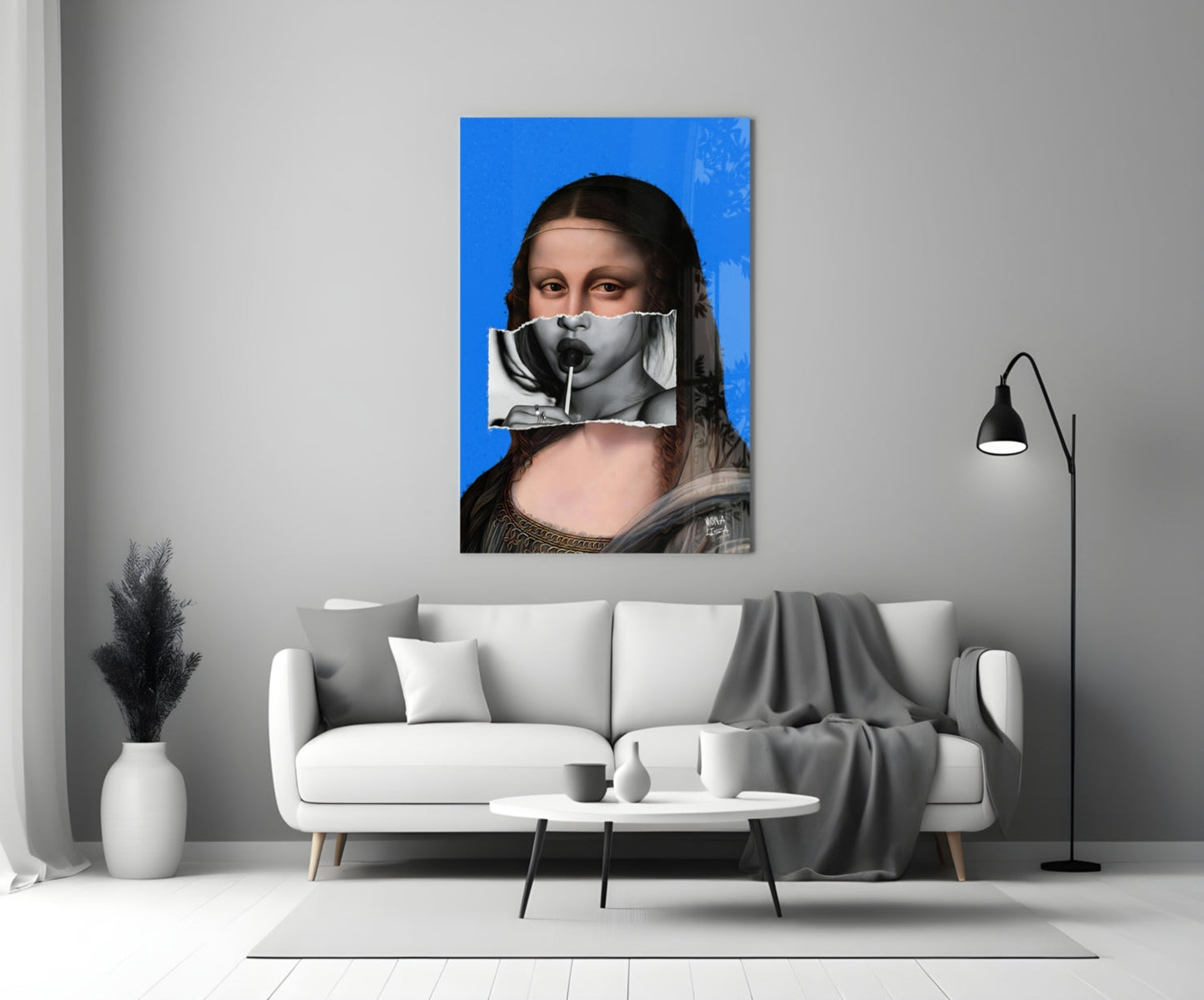 Contemporary glass wall art depicting Mona Lisa with blue background and collaged mouth detail, displayed above white sofa in minimalist interior.