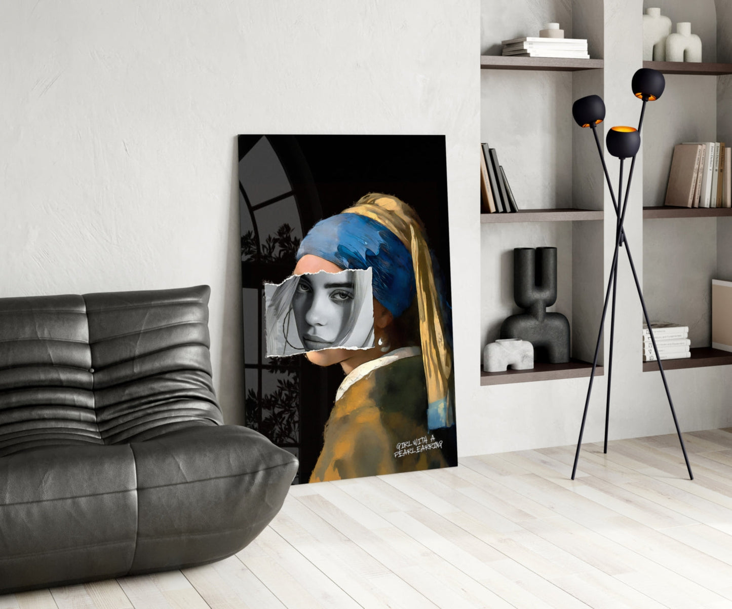 Modern living room displaying glass wall art of girl with pearl earring, blue headwrap, and grayscale face overlay against black background.