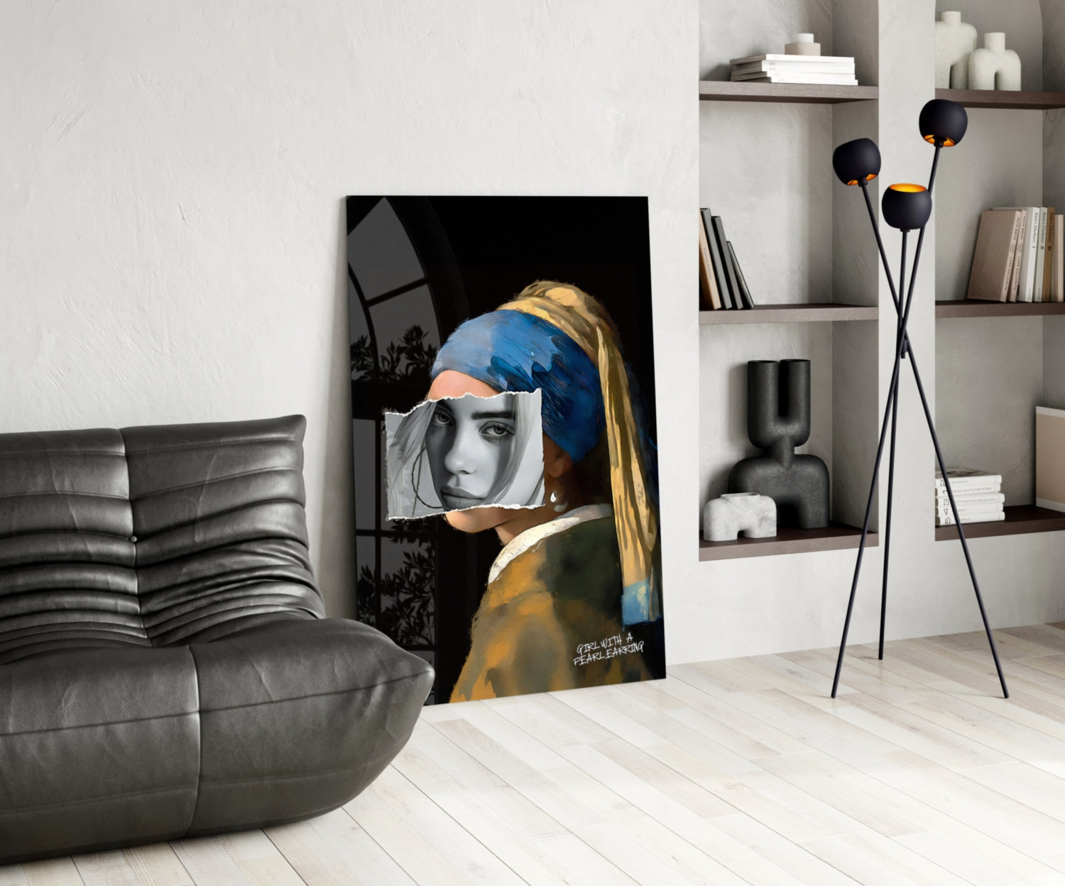 Modern living room displaying glass wall art of girl with pearl earring, blue headwrap, and grayscale face overlay against black background.
