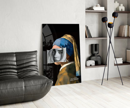 Modern living room displaying glass wall art of girl with pearl earring, blue headwrap, and grayscale face overlay against black background.