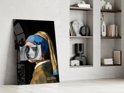 Modern interior setting displaying a leaning glass art panel featuring a girl with blue headwrap and gold earring against dark background, alongside white shelving with books and decorative objects.