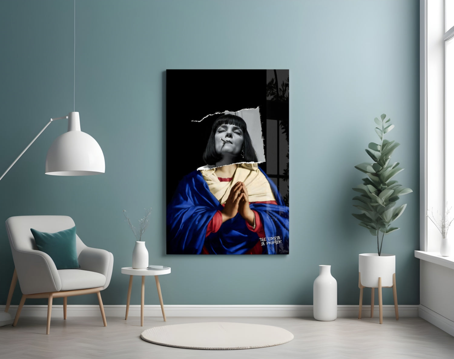 Contemporary glass wall art depicting a figure in blue and gold robes holding a book against a black background, displayed in a minimalist room setting.