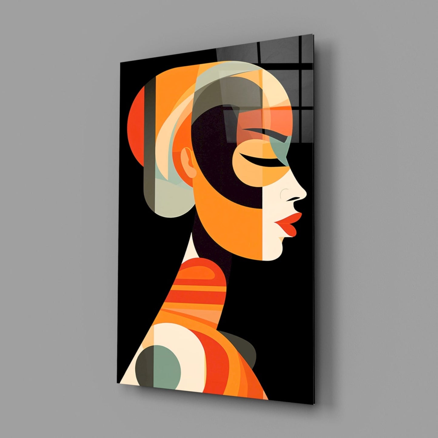 Modern glass wall art featuring an abstract profile portrait with orange, cream, and black geometric shapes against a dark background, displayed at an angle.