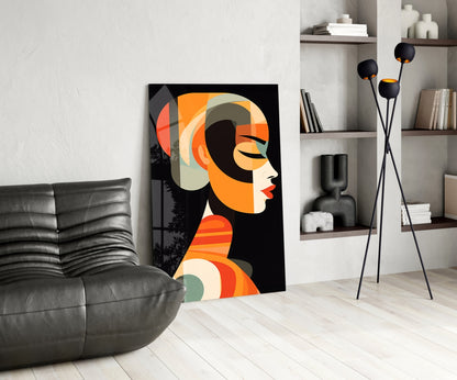 Modern living room displaying geometric art glass panel featuring stylized female profile in orange, cream, and black tones.