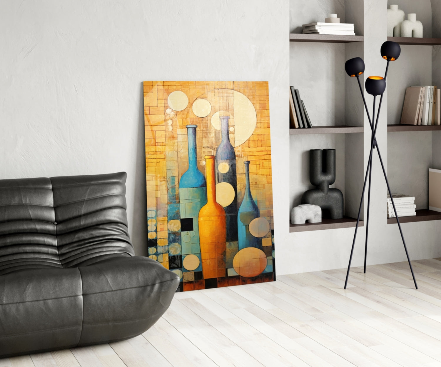 Modern living room interior featuring colorful glass bottle wall art in warm oranges and blues displayed against white wall beside black leather chair.