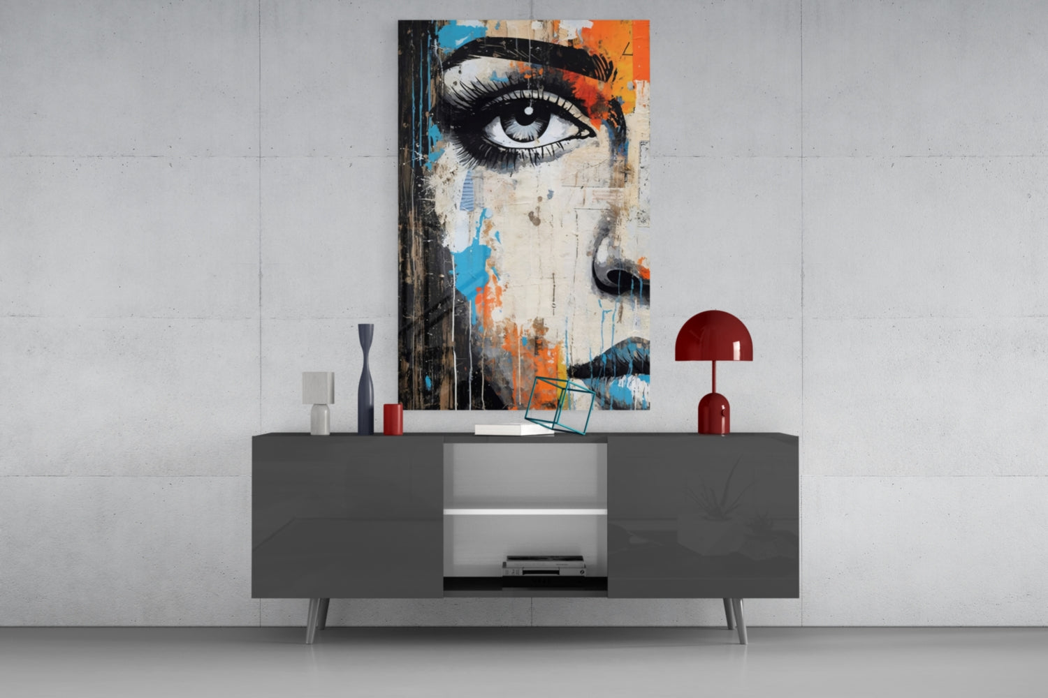 Modern living room display featuring half-portrait glass wall art with eye and colorful abstract elements above dark gray media console.