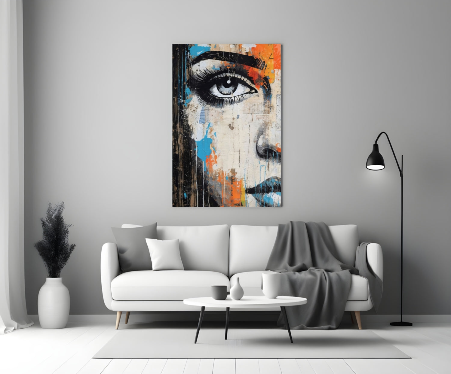 Modern living room with white sofa displaying colorful abstract half-face glass art above, featuring blue and orange paint strokes.