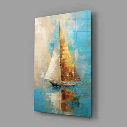 Angled view of a glass wall art panel featuring a sailboat with white and golden sails against turquoise and cream layered background.
