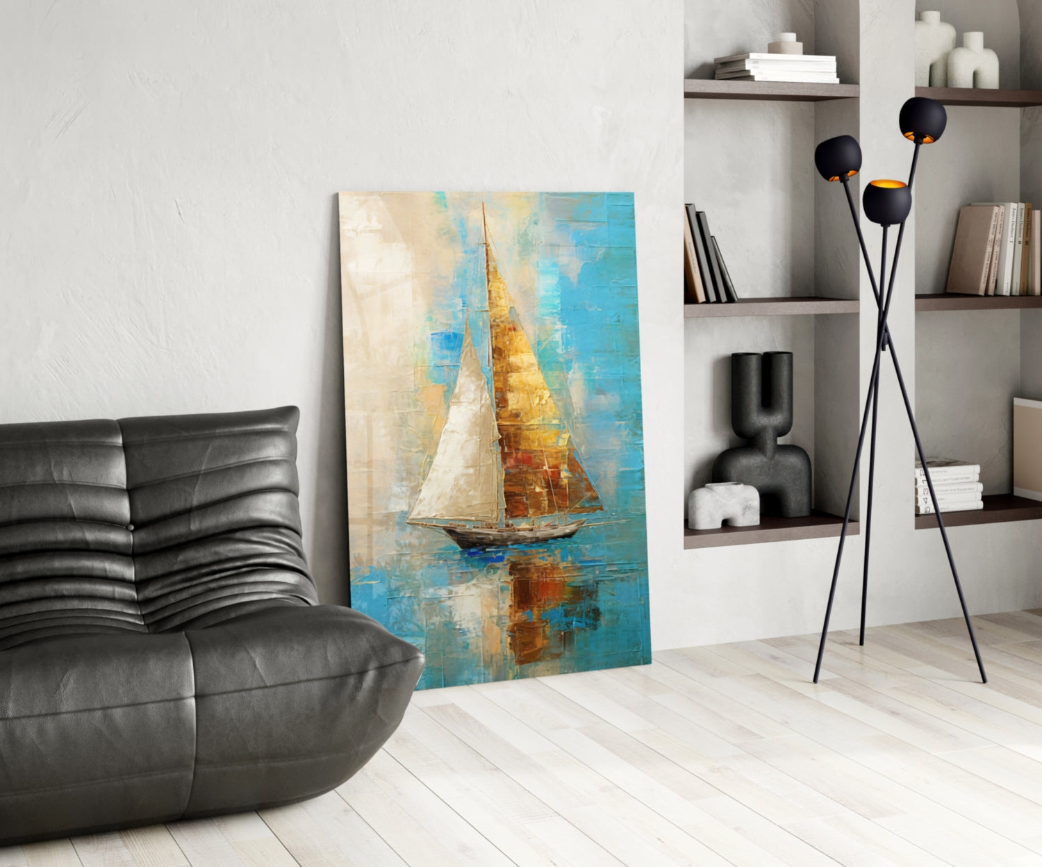 Modern living room featuring sailboat glass wall art with blue, gold, and cream tones displayed between black leather chair and white shelving unit.