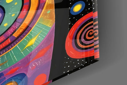 Two angled glass panels displaying colorful concentric circles and celestial designs in red, orange, purple, and teal against black backgrounds with white stars.