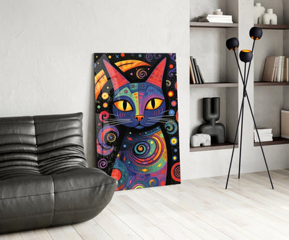 Colorful psychedelic cat artwork with yellow eyes and spiral patterns displayed on wall beside black leather sofa and modern shelving.