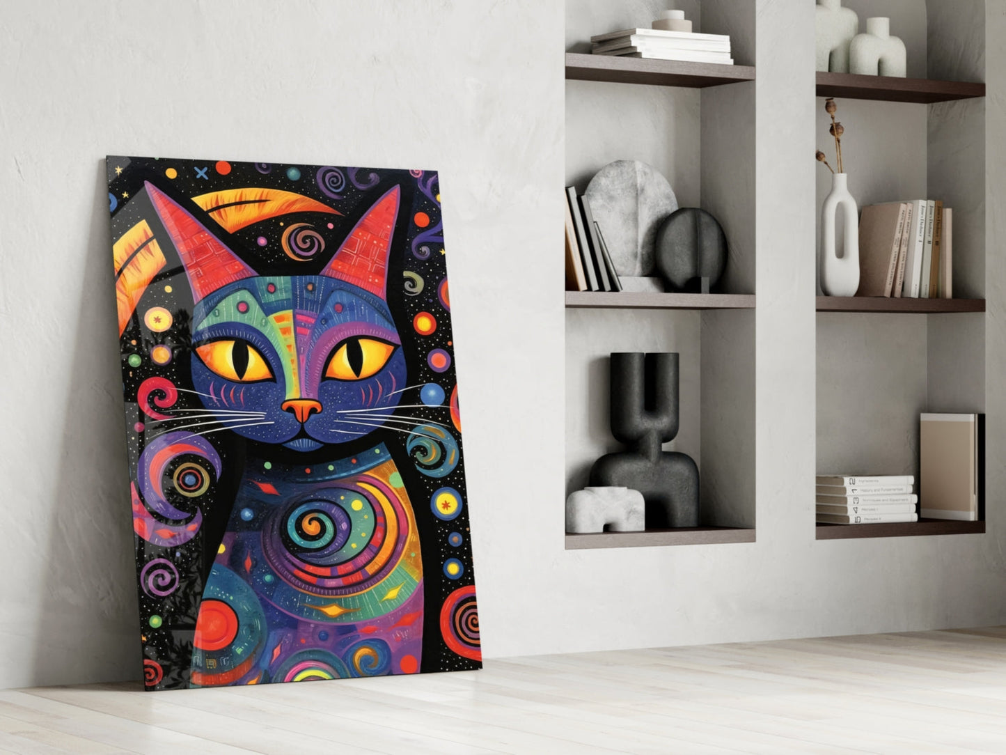 Colorful pop art cat canvas with yellow eyes and geometric patterns leaning against white wall next to shelving.