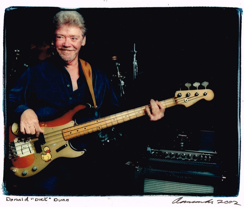 Axe Heaven Fender Precision Bass Mini with colorful cartoon inlay on adjustable A-frame stand