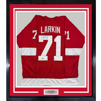 Red Detroit Red Wings hockey jersey number 71 with "LARKIN" nameplate and signature, displayed flat in black frame with red matting and white borders.