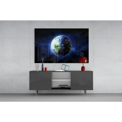 Sleek gray console table with open shelving under Earth from space wall art