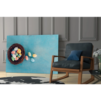 Vibrant glass wall art of blue canvas with woven nest and colorful Easter eggs