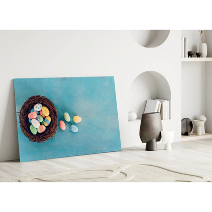 Vibrant glass wall art of blue canvas with woven nest and colorful Easter eggs
