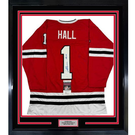 Framed red Chicago Blackhawks #1 hockey jersey with "HALL" nameplate and signature, displayed front-center against white backing with red and black border frame.