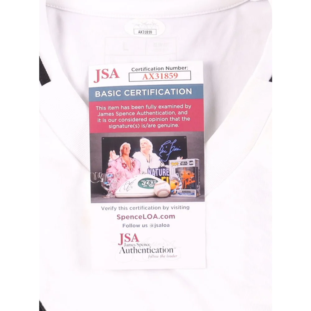 White Real Madrid jersey with authentication tag signed by Eder Militao