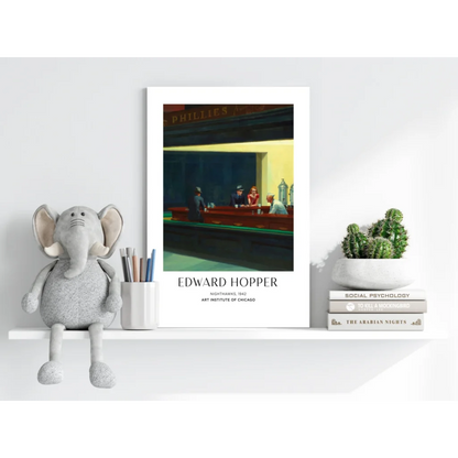 White-framed Edward Hopper Nighthawks 1942 print with moody diner blues and yellows