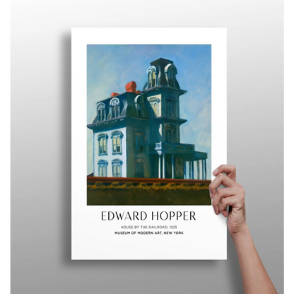 Hand holding vintage teal white Edward Hopper House by the Railroad poster print