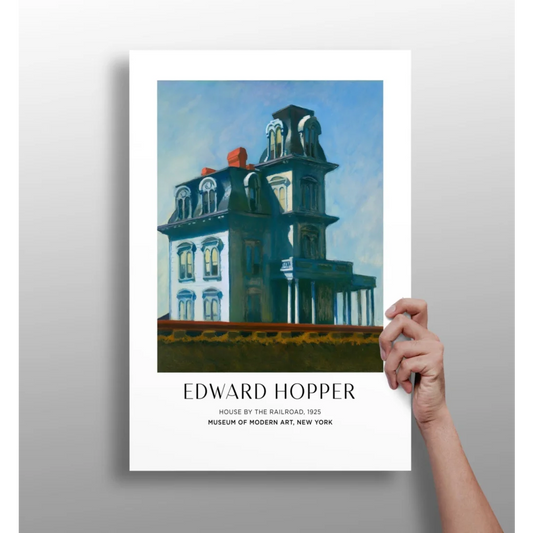 Hand holding vintage teal white Edward Hopper House by the Railroad poster print