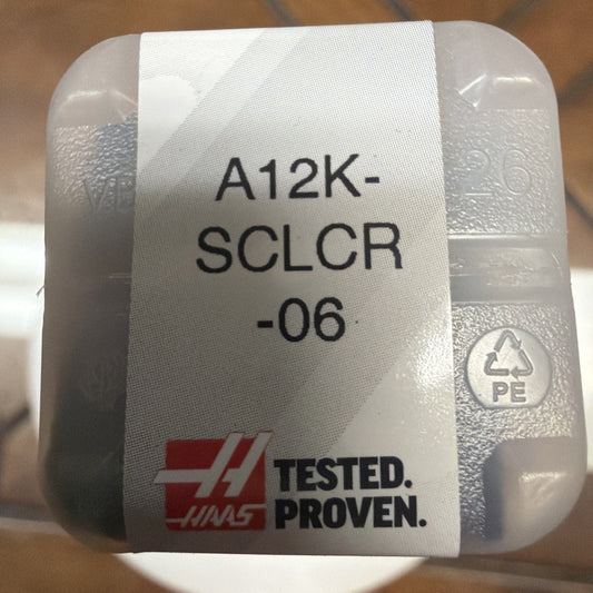 Clear plastic packaging containing gray metallic boring bar holder labeled A12K-SCLCR-06 with Haas "Tested. Proven." branding and PE recycling symbol visible.