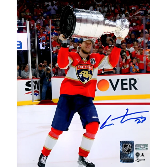 Eetu Luostarinen holds Stanley Cup Trophy in Florida Panthers jersey